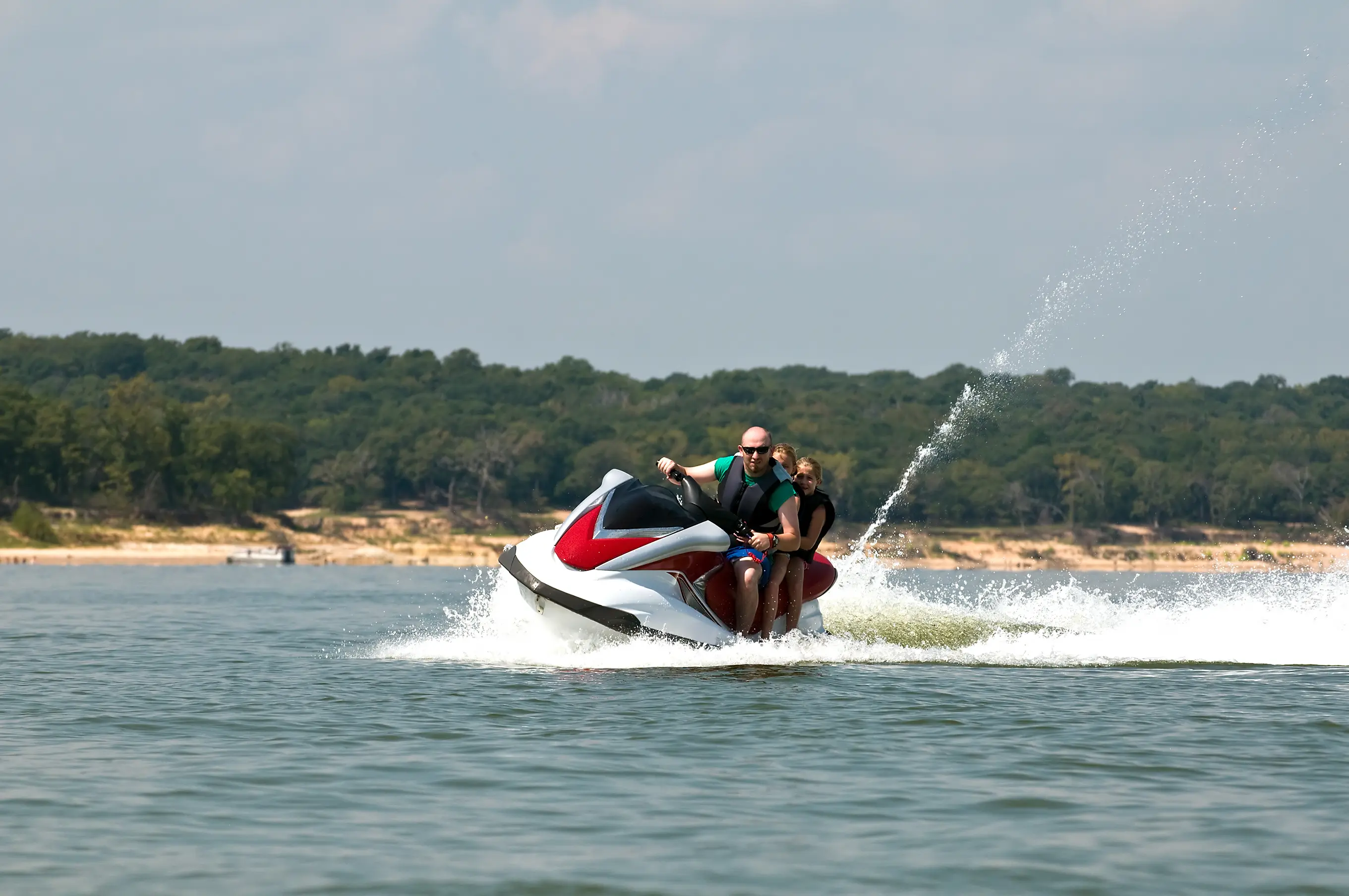 A couple of people on a jet ski in the water.