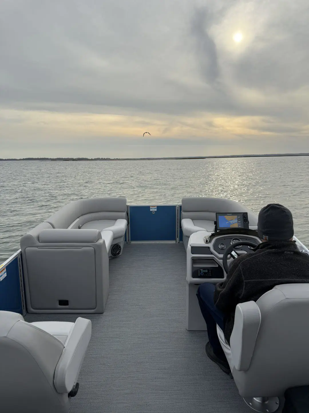 A man sitting on top of a boat in the water.