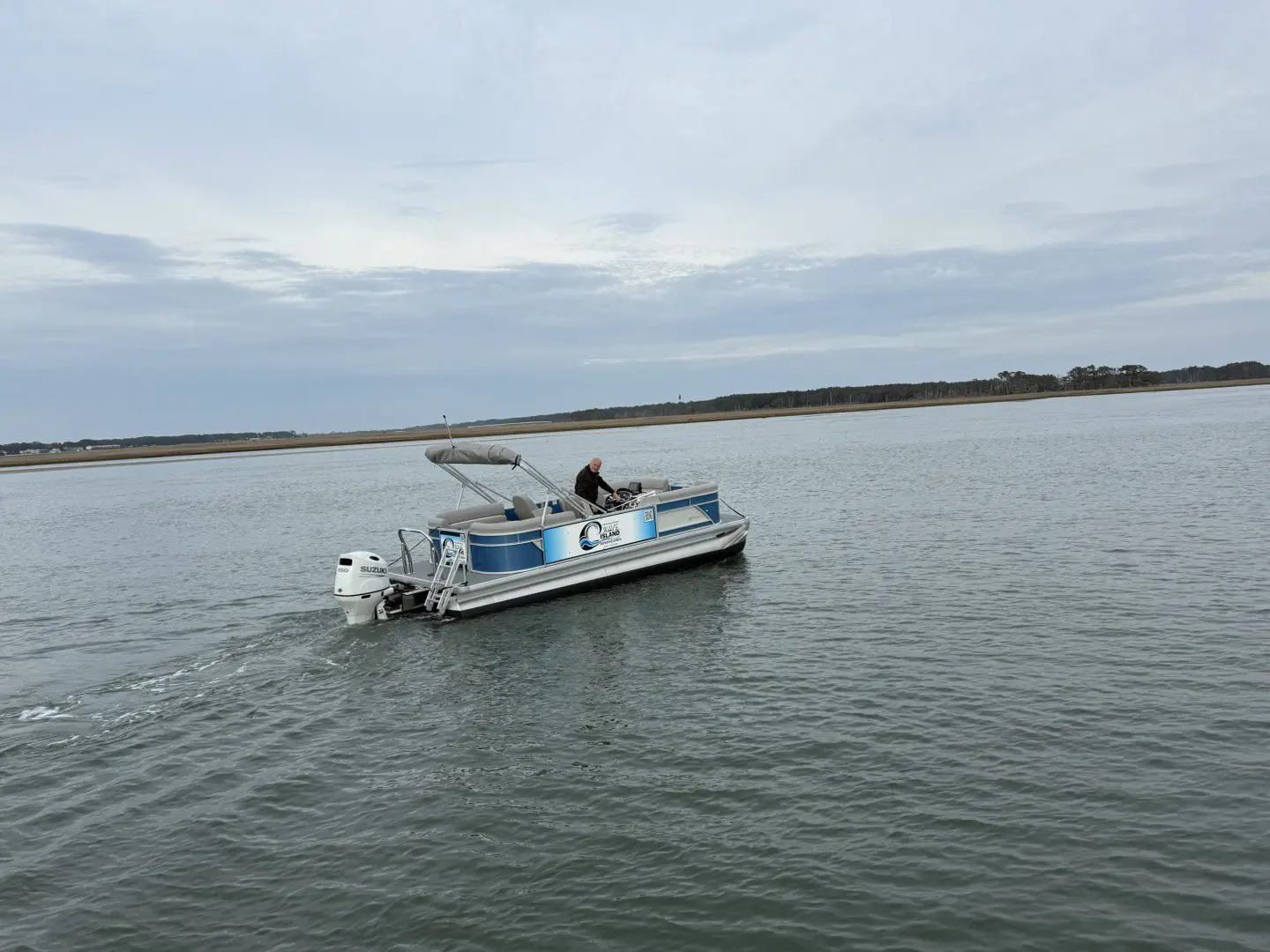 A boat is in the water on a cloudy day.